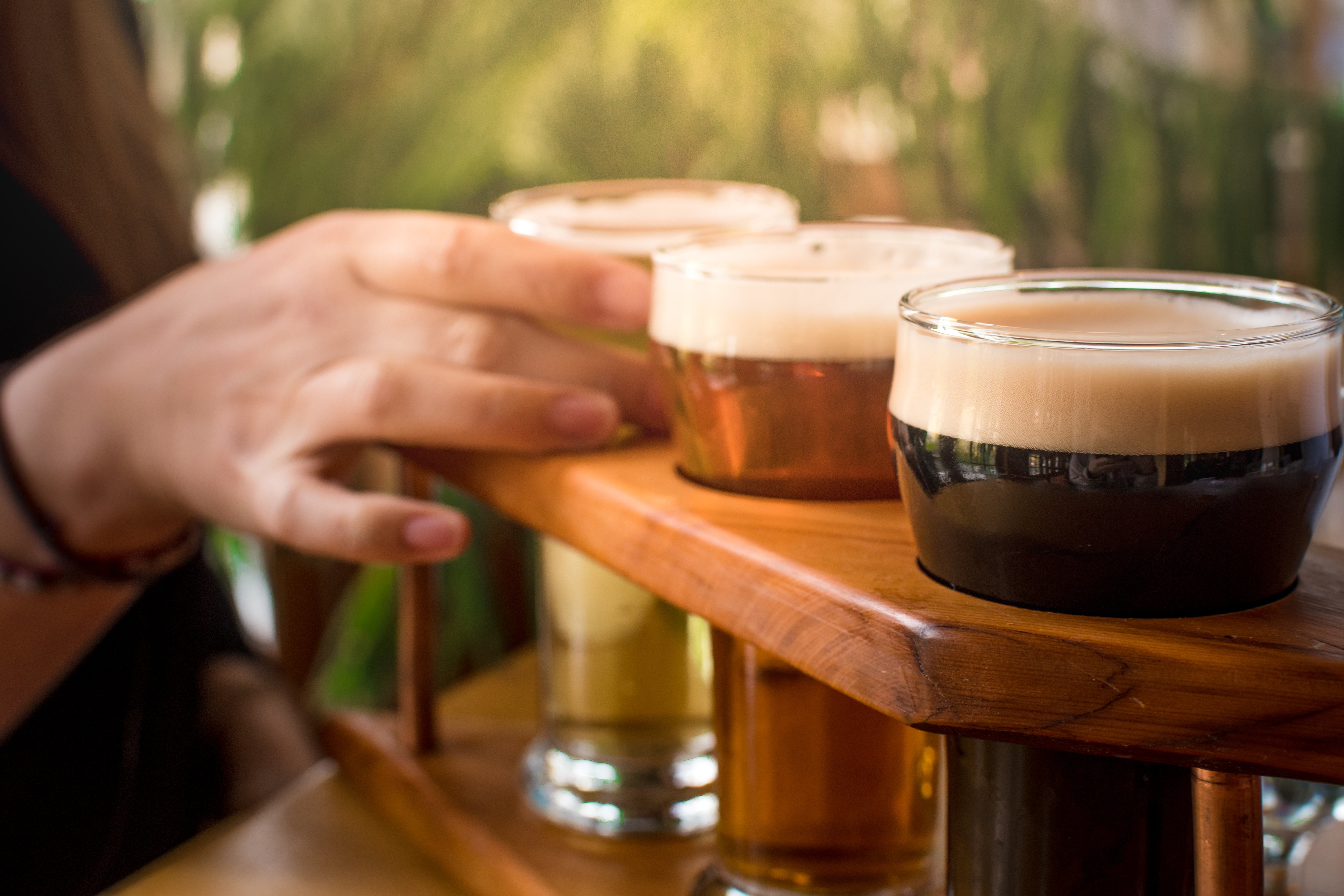 person_holding_clear_drinking_glass_with_brown_liquid-scopio-c5b69d58-e468-4112-8c5d-a3903b74951b